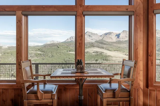 a view of a city from a dining room with large windows