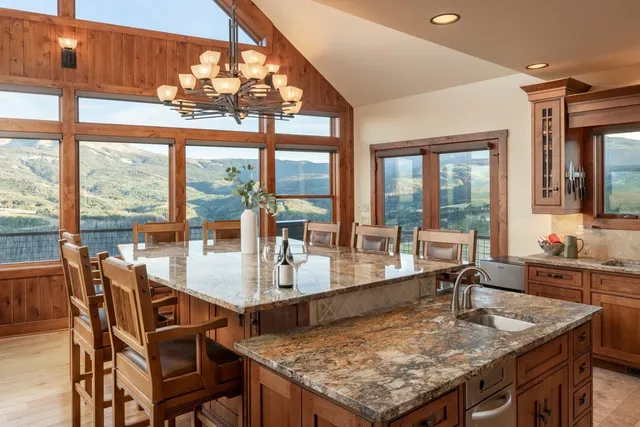 a view of a dining room with furniture wooden floor and chandelier