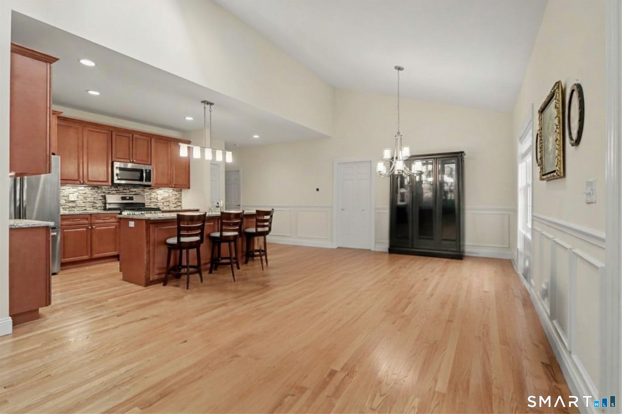 223 Meadow Brook Road, Unit 223 Oxford, CT 06478 - Photo 34 of 34 a kitchen with stainless steel appliances a refrigerator and a wooden floor