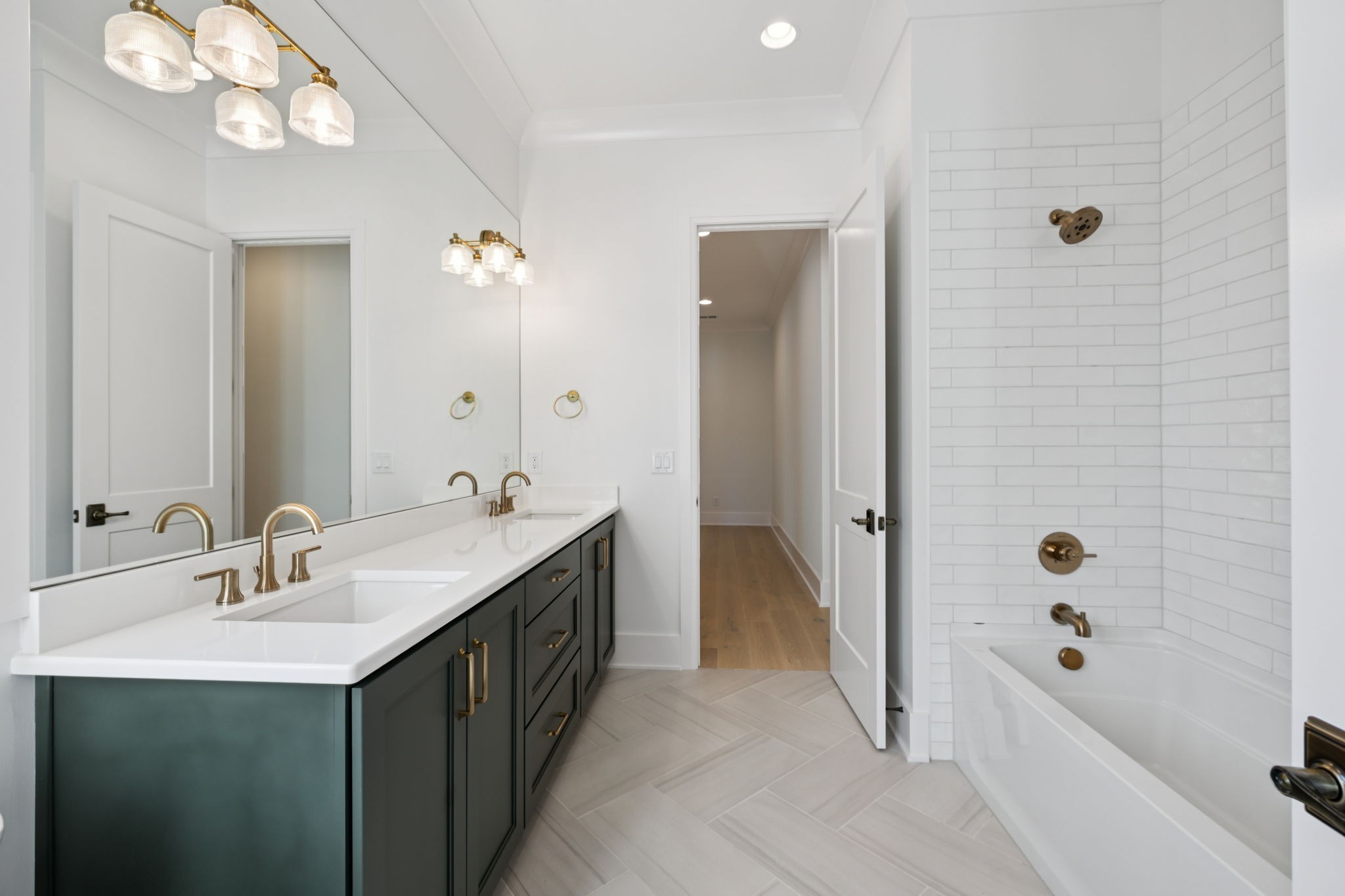 1408 Adams Street Franklin, TN 37064 - Photo 64 of 74 a bathroom with a double vanity sink a mirror a bathtub and shower