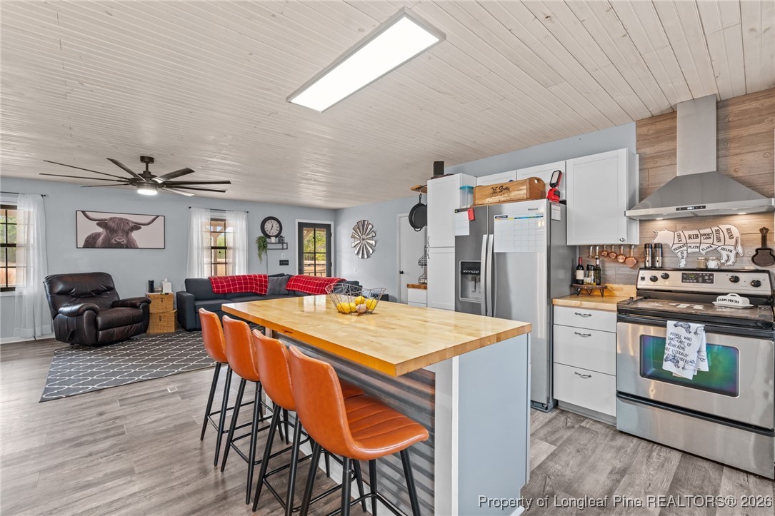 2229 Tingen Road Lillington, NC 27546 - Photo 18 of 50 a dining room with stainless steel appliances kitchen island granite countertop a dining table and chairs