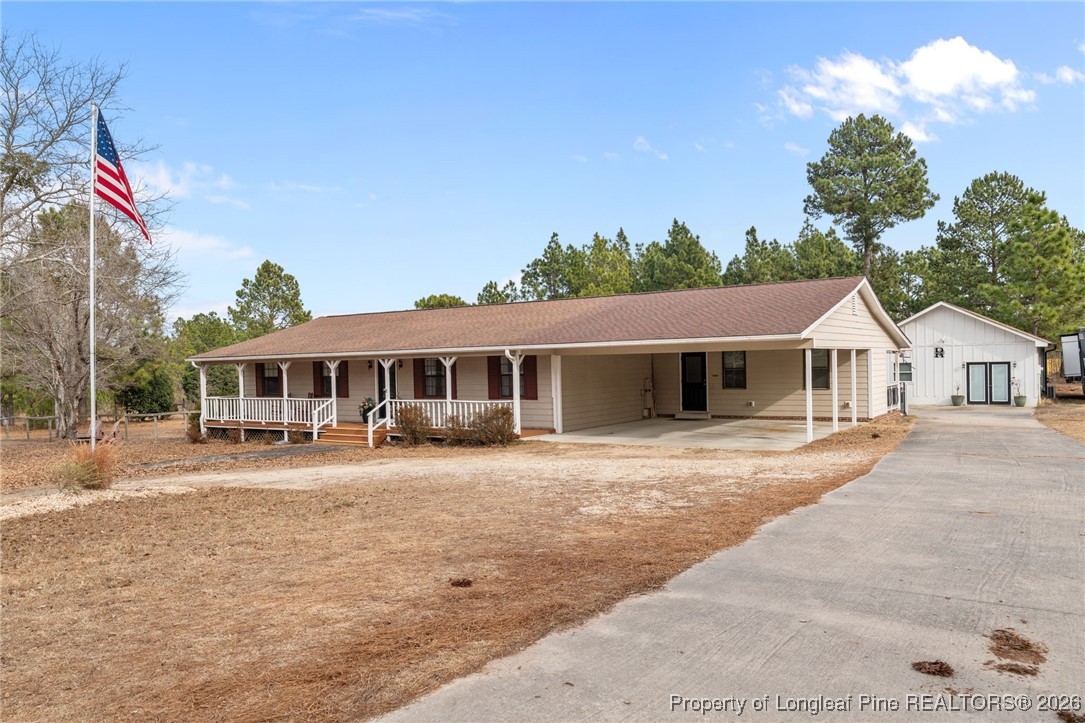 2229 Tingen Road Lillington, NC 27546 - Photo 3 of 50 a front view of a house with a yard and trees