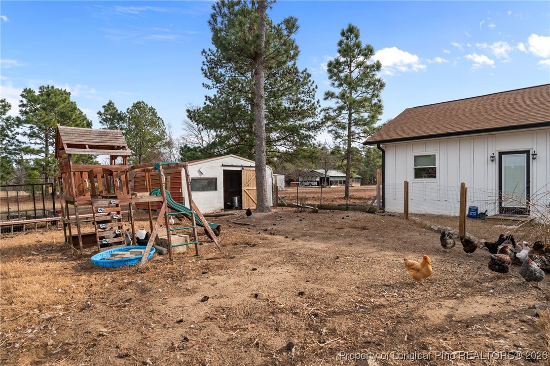 2229 Tingen Road Lillington, NC 27546 - Photo 50 of 50 a view of a backyard with a table and chairs