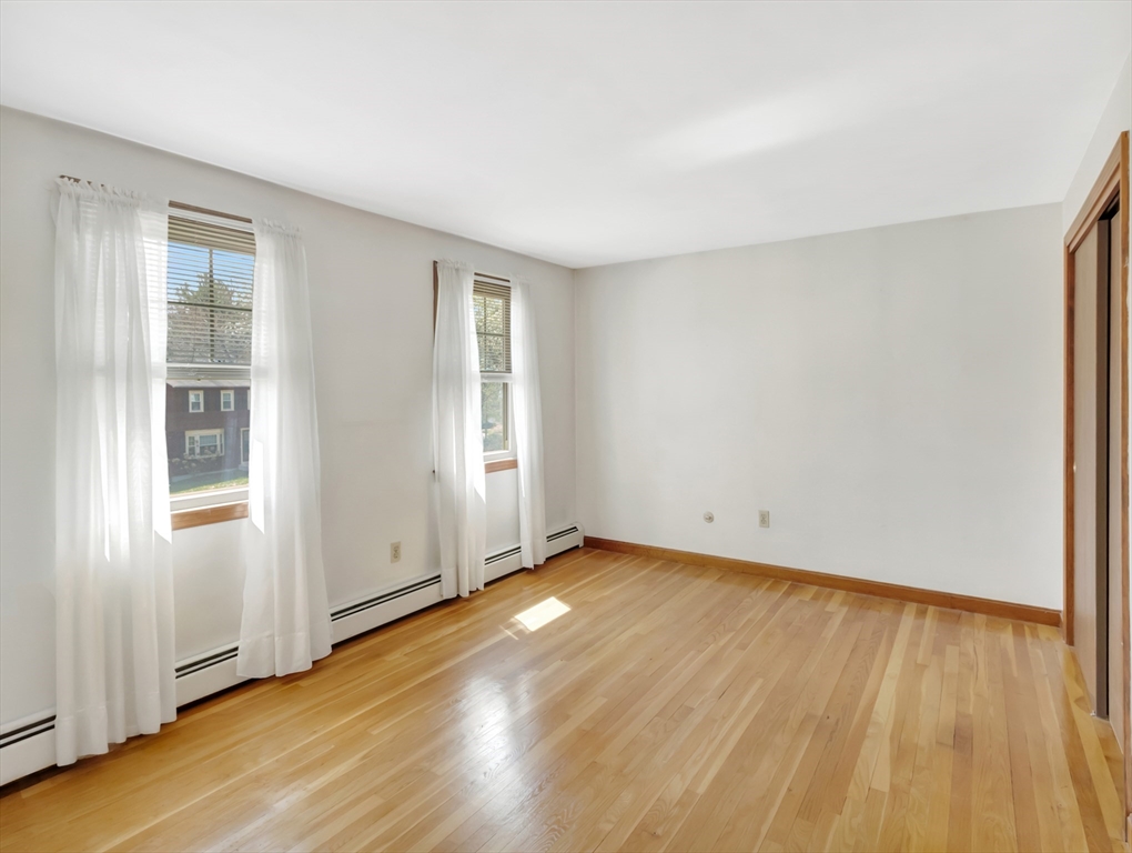 15 Riverside Drive Mansfield, MA 02048 - Photo 22 of 42 an empty room with wooden floor and windows