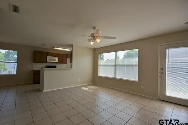 a view of an empty room with a ceiling fan