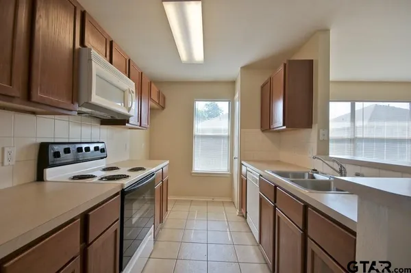 a kitchen with a sink stove and cabinets