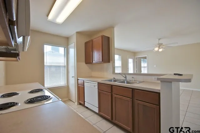 a kitchen with a sink stove and cabinets