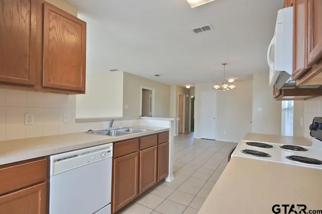 a kitchen with a sink stove and cabinets