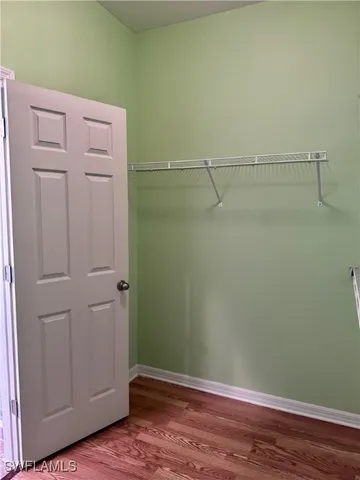 a view of a room with wooden floor