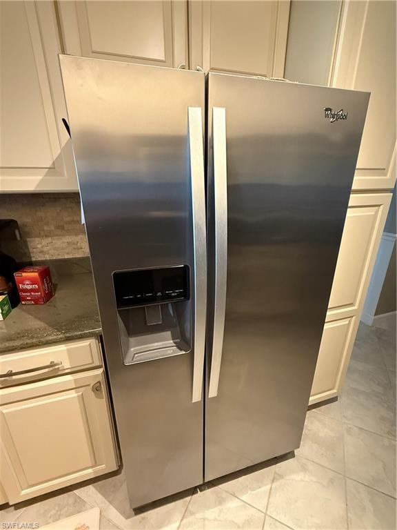 760 Augusta Boulevard, Unit D204 Naples, FL 34113 - Photo 21 of 32 a metallic refrigerator freezer sitting inside of a kitchen