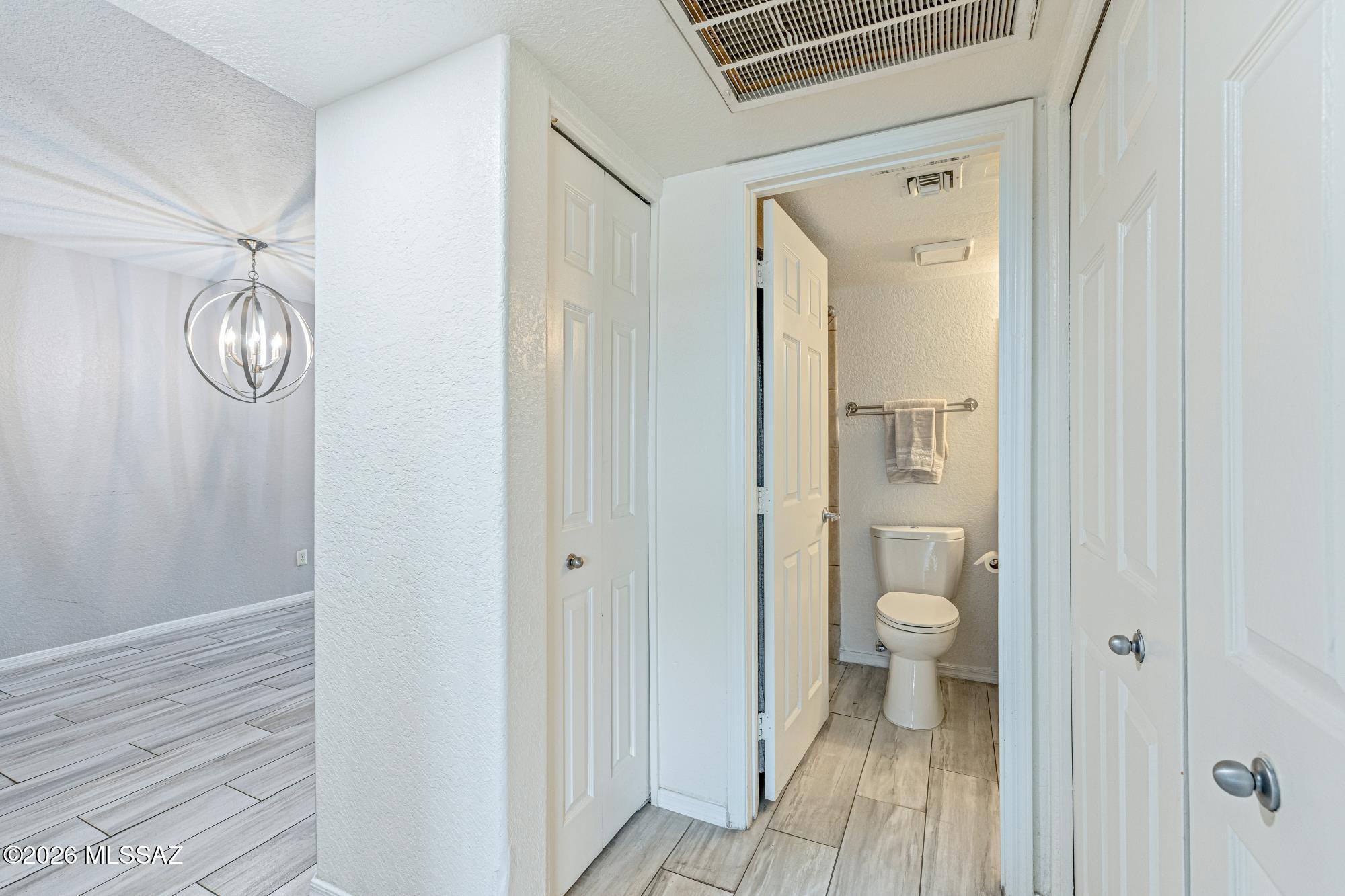 5800 North Kolb Road, Unit 1104 Tucson, AZ 85750 - Photo 16 of 29 Looking out the second bedroom towards the second/guest bathroom. There is a linen closet to your left and the washer/dryer closet to your right.