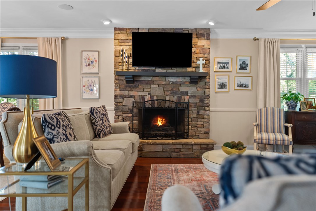 3513 Hopewell Road Anderson, SC 29621 - Photo 20 of 50 A comforting living room offers rich hardwood floors and a stacked stone fireplace.