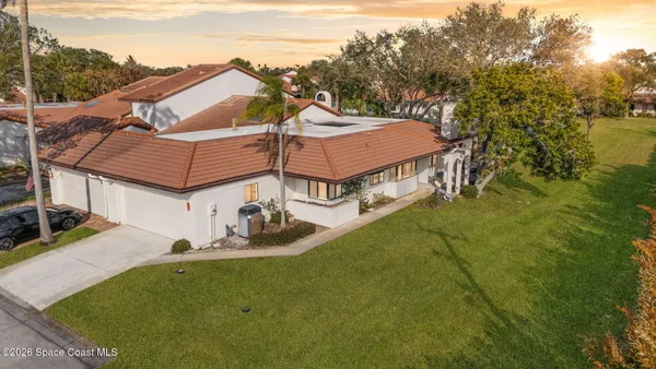 an aerial view of a house with swimming pool garden and patio