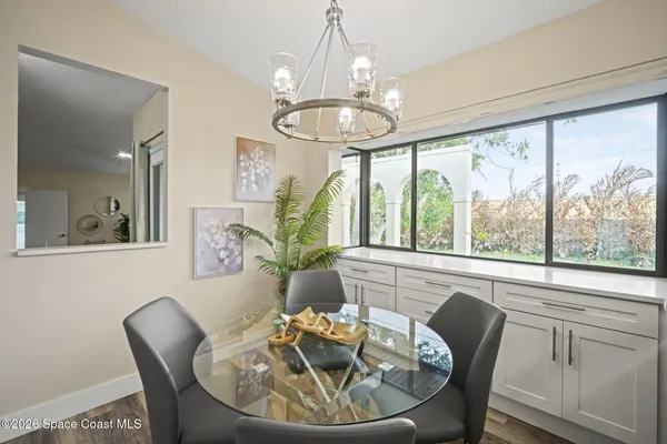 a view of a dining room with furniture window and wooden floor