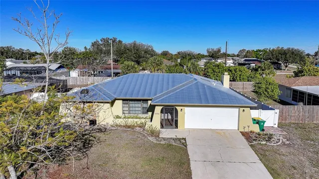 a view of a house with a yard and sitting area