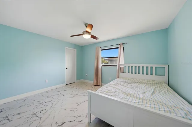 a bedroom with a large bed and a chandelier