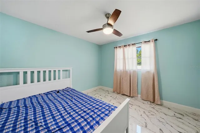 a bedroom with a bed and a rug