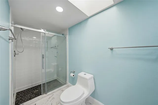 a spacious bathroom with a granite countertop sink and a mirror
