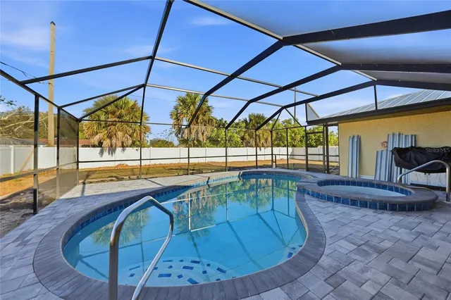 a view of a swimming pool with a lounge chairs