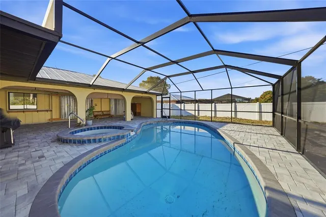 a view of a swimming pool with a patio