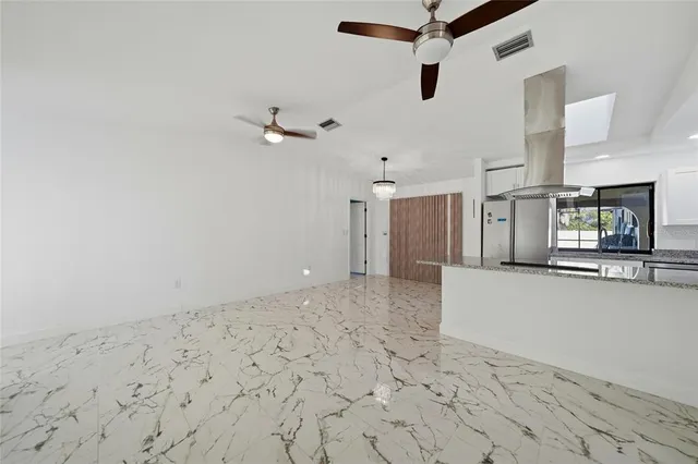a view of a kitchen with a sink and a refrigerator
