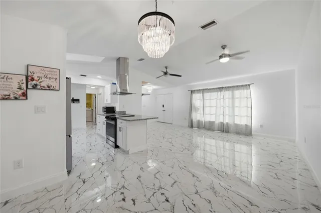 a kitchen with granite countertop a sink and stainless steel appliances