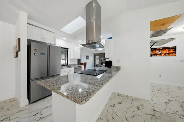 a kitchen with granite countertop a sink stove and cabinets