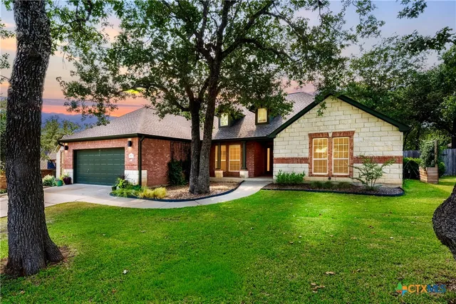 a front view of house with yard outdoor seating and green space