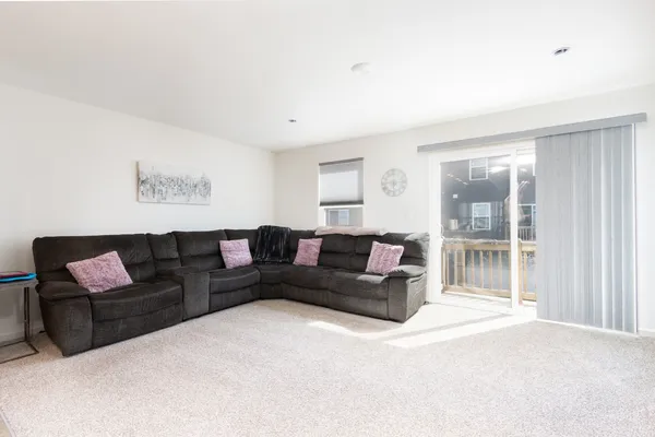 a living room with a couch and a large window