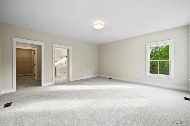 an empty room with windows and closet