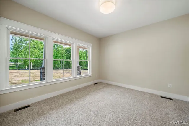 an empty room with closet and fan