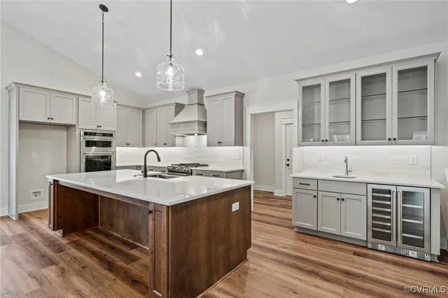 a kitchen with kitchen island a sink stainless steel appliances and cabinets