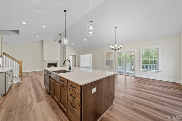 a kitchen with kitchen island a sink stove and wooden floor