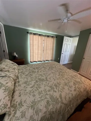 a bedroom with a large bed and a chandelier