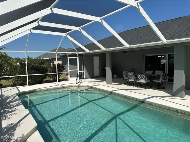 a view of swimming pool with seating area