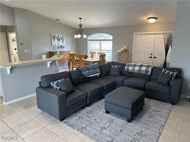 a living room with furniture and a chandelier