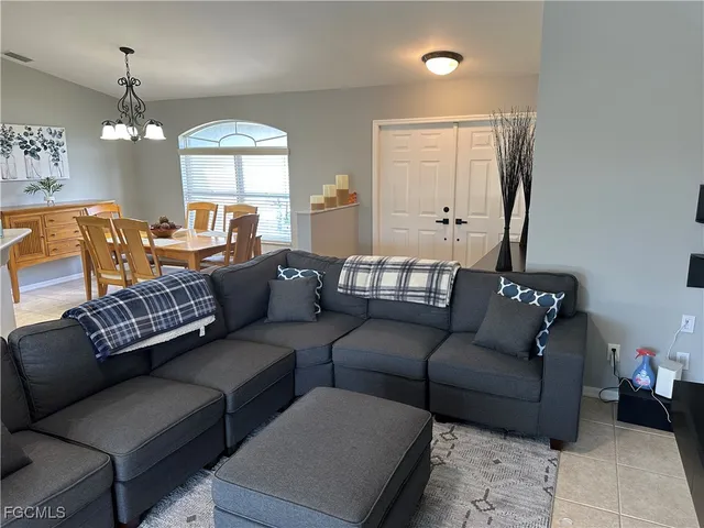 a living room with furniture ceiling fan and a window