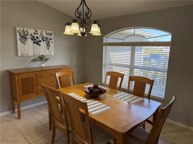 a view of a dining room with furniture and chandelier