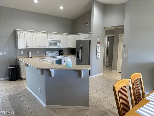 a kitchen with stainless steel appliances granite countertop a sink a stove and a refrigerator