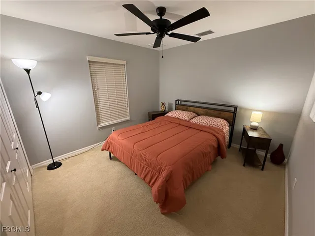 a bedroom with a bed and a ceiling fan