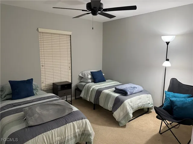 a bedroom with bed and a window