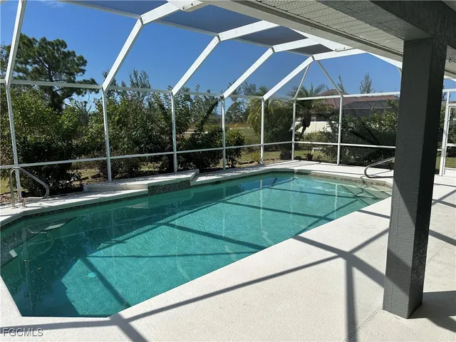 a view of a tennis ground with large trees