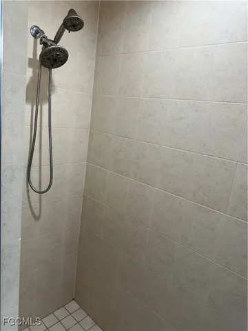 a bathroom with a tub shower and vanity