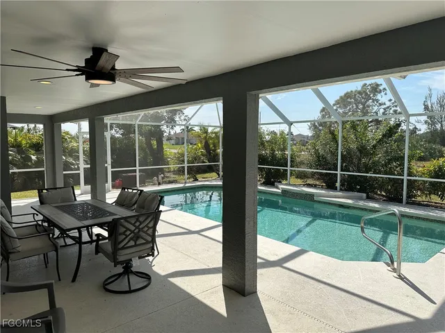 a view of a porch with furniture and a backyard