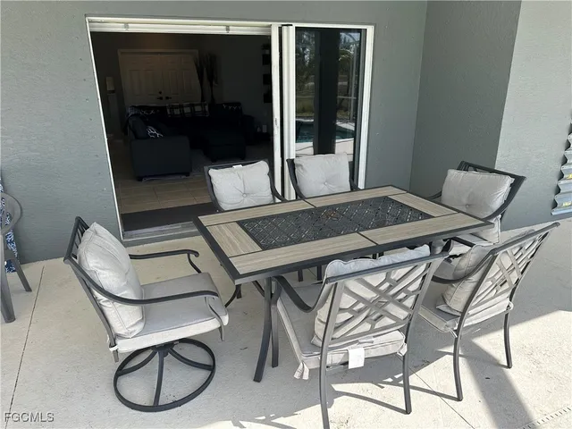 a patio with a table and chairs