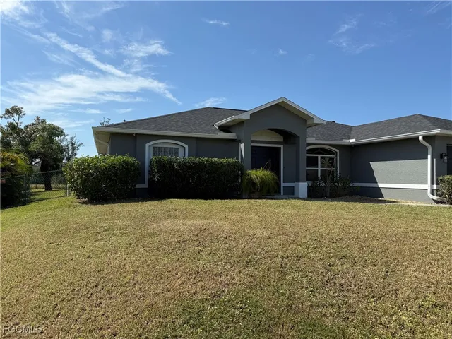a front view of a house with a yard
