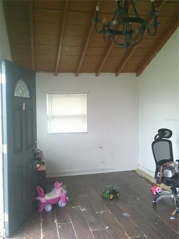 an empty room with wooden floor