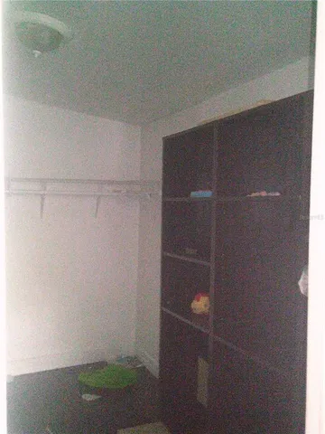 a room with a sink cabinets and wooden floor