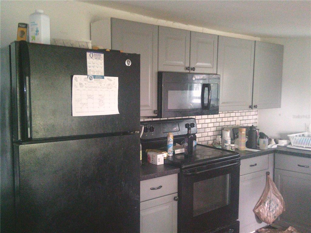11951 Wichers Road San Antonio, FL 33576 - Photo 39 of 41 a kitchen with stainless steel appliances granite countertop a sink stove and refrigerator