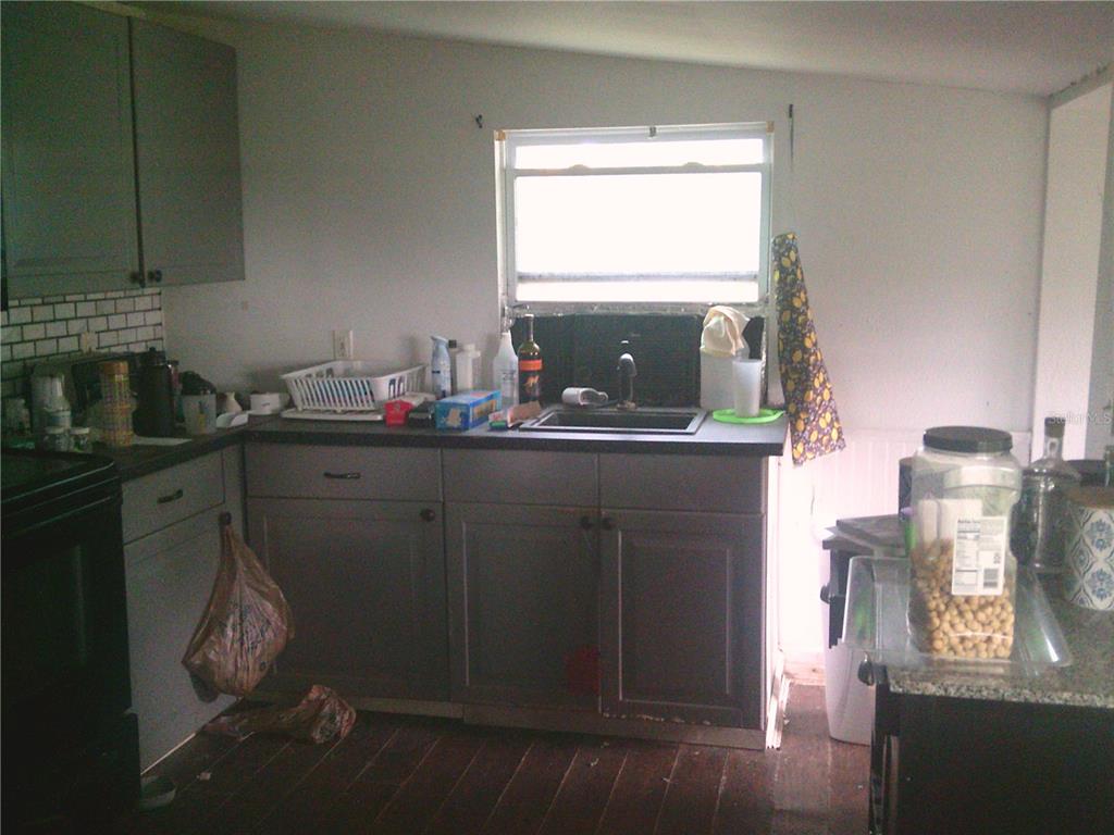 11951 Wichers Road San Antonio, FL 33576 - Photo 40 of 41 a room with a sink cabinets and wooden floor